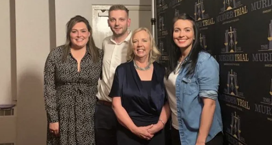 Rebecca and colleagues at a Murder Trial Live event, standing before a branded backdrop
