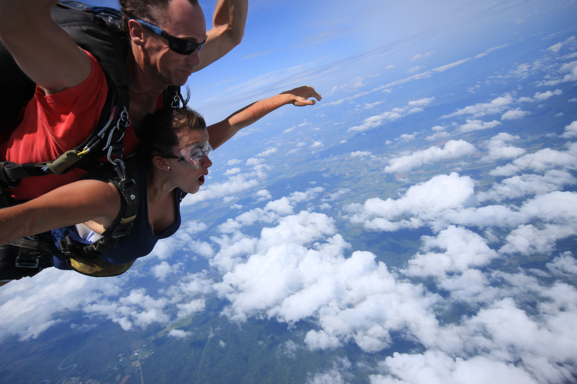 Rebecca tandem skydiving above the clouds