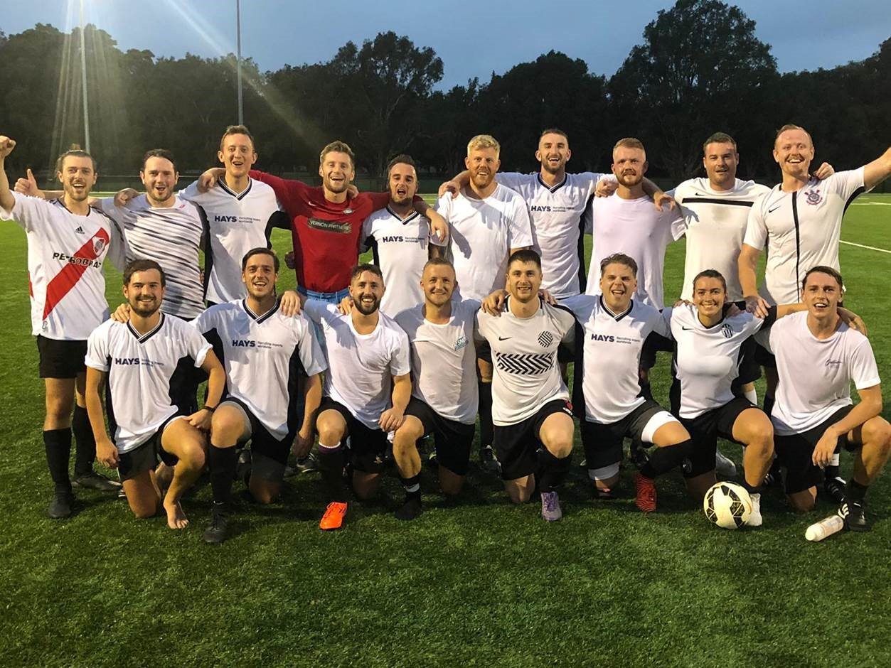 Rebecca lined up with her mixed football team on the pitch at dusk